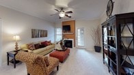 This single-story residence in Winchester offers a well-organized layout across two bedrooms and two bathrooms. The living room serves as the central gathering space, featuring a ceiling fan, plush carpeting, crown molding, and a fireplace framed by a bold accent wall. Natural light enters through multiple windows, and a door provides direct outdoor access. Adjacent to the living room, the dining area accommodates a round table beneath a pendant light fixture, complemented by tile flooring and a large decorative mirror.

The kitchen is equipped with dark espresso cabinetry, granite-style countertops, stainless steel appliances including a range and built-in microwave, a double basin sink, and tile flooring throughout.

Both bedrooms feature ceiling fans, plush carpeting, and windows that allow natural light. The primary bedroom includes dual windows and ample space for large furniture. The second bedroom similarly offers a comfortable, well-lit environment.

Each bathroom is finished with dark wood-look flooring, dark cabinetry with granite-style countertops, a single vanity sink, and a shower-tub combination, providing a consistent and cohesive aesthetic throughout the home.