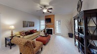 This single-story residence in Winchester offers a well-organized layout across two bedrooms and two bathrooms. The living room serves as the central gathering space, featuring a ceiling fan, plush carpeting, crown molding, and a fireplace framed by a bold accent wall. Natural light enters through multiple windows, and a door provides direct outdoor access. Adjacent to the living room, the dining area accommodates a round table beneath a pendant light fixture, complemented by tile flooring and a large decorative mirror.

The kitchen is equipped with dark espresso cabinetry, granite-style countertops, stainless steel appliances including a range and built-in microwave, a double basin sink, and tile flooring throughout.

Both bedrooms feature ceiling fans, plush carpeting, and windows that allow natural light. The primary bedroom includes dual windows and ample space for large furniture. The second bedroom similarly offers a comfortable, well-lit environment.

Each bathroom is finished with dark wood-look flooring, dark cabinetry with granite-style countertops, a single vanity sink, and a shower-tub combination, providing a consistent and cohesive aesthetic throughout the home.