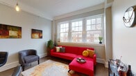 Situated in the heart of downtown Columbus, Ohio, this single-floor urban residence offers a thoughtfully designed layout that balances comfort and city living. The living area serves as the focal point of the space, featuring a bank of large double-hung windows that flood the room with natural light while framing views of the surrounding brick buildings. The open, airy feel is complemented by neutral wall tones and hardwood flooring. The kitchen is well-equipped with stainless steel appliances, including a full-size refrigerator, electric range, and over-the-range microwave. Crisp white shaker-style cabinetry reaches toward the ceiling, maximizing storage, while light quartz countertops extend into a peninsula with bar seating — ideal for casual dining or entertaining. The bedroom is a tranquil retreat, featuring a wall of windows that invite natural light and offer urban rooftop views, along with a spacious sliding-door closet. The bathroom features polished concrete floors, a vanity with ample counter space, and a bright window for natural ventilation. Throughout the residence, a mix of polished concrete and warm flooring adds an urban-industrial character that complements the downtown Columbus setting.