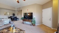 Located at 2299 Oakmont Dr in Sierra Vista, Arizona, this single-story, three-bedroom, two-bathroom home offers a well-designed layout that maximizes functionality and comfort. The open living room features vaulted ceilings with a ceiling fan, neutral-toned carpet, and ample natural light, creating a warm and inviting atmosphere. The space flows naturally toward the kitchen, which is outfitted with warm wood cabinetry, dark granite countertops, tile flooring, and full appliances including a Whirlpool refrigerator and stainless range. The three bedrooms are carpeted and bright, each benefiting from large windows with horizontal blinds. The primary bedroom is generously sized and connects to a full bathroom featuring dark wood vanity cabinetry, granite countertops, tile flooring, and a walk-in closet with built-in hanging storage. A second full bathroom serves the remaining bedrooms and includes a tub/shower combination, wood vanity, and tile flooring. The dedicated laundry area houses full-size Maytag washer and dryer units alongside an in-unit water heater, adding everyday convenience. Throughout the home, warm beige tones and consistent finishes create a cohesive, comfortable living environment well-suited for Sierra Vista's relaxed lifestyle.