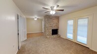 Located at 5303 11th Street in Lubbock, Texas, this single-story home offers a practical and comfortable layout with several notable features throughout. The main living area serves as the centerpiece of the home, highlighted by a floor-to-ceiling brick fireplace that adds architectural character and warmth to the space. Plush carpeting covers the living area floor, while a ceiling fan overhead provides year-round comfort. A set of exterior-facing doors allows natural light to filter into the living space, creating a bright and welcoming atmosphere. An adjacent area with wood-look flooring provides additional flexible living space, also equipped with a ceiling fan.

The kitchen is outfitted with warm wood cabinetry, light countertops, a white electric coil-burner range with an overhead ventilation hood, and wood-look flooring, offering a functional cooking environment.

The bedrooms are carpeted and well-lit, each featuring ceiling fans and ample closet space. The bathrooms include a full bath with a tub-shower combination and wood-look flooring, as well as a second bath with a vanity, mirror, and light fixture. Textured ceilings are consistent throughout the home, contributing to its classic residential character.