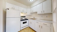 This single-floor unit in Saginaw, Michigan, offers a practical and comfortable layout designed to maximize functionality. The open living and dining area is generously sized, featuring neutral carpet flooring, large windows that invite abundant natural light, and views of the surrounding exterior. Baseboard heating runs along the walls, ensuring consistent warmth throughout the space. A ceiling fan is positioned in the adjoining area, adding both airflow and a subtle design element.

The kitchen is efficiently organized, featuring white cabinetry that extends to the upper walls for ample storage, light-toned countertops, a stainless single-basin sink, and white appliances including a gas range with overhead ventilation and a full-size refrigerator. The tile flooring provides easy maintenance in this functional cooking space.

The bedroom is a well-proportioned retreat with soft carpeting, a ceiling fan with a light fixture, a window unit for climate control, and a closet with double doors offering practical storage. The full bathroom presents a clean, utilitarian design with small-tile flooring, a vanity with under-cabinet storage, a wall-mounted mirror, and a tub and shower combination finished in white tile. The overall aesthetic throughout the unit is clean and neutral, providing a versatile canvas for personalization.