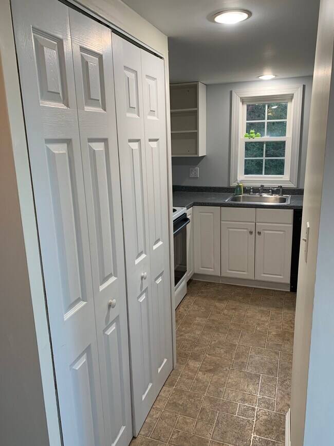 Closet at left with washer/dryer stack. - 741 Cherry Valley Rd
