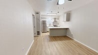 This well-designed one-bedroom, one-bathroom unit offers a smart and functional layout across a single floor, making the most of every square foot. The open-concept living and kitchen area serves as the heart of the home, where light wood-style flooring, neutral wall tones, and a textured ceiling create a clean, cohesive aesthetic. A ceiling fan anchors the living space, while the kitchen stands out with its striking marble-look quartz peninsula countertop — ideal for dining or casual entertaining. Pendant Edison bulb lighting adds a modern industrial touch overhead. The kitchen is fully equipped with sage-toned cabinetry, a gas range and oven, a stainless steel refrigerator, a stainless wall-mounted range hood, and a black-fixture sink, all framed by a bright window that draws in natural light. A pantry provides additional storage convenience. The bedroom is a calm, neutral retreat with a window offering outside views, light wood-style flooring, and a dedicated closet. The bathroom features a full-size tub-shower combination with clean white surrounds and matte black hardware accents. The unit also includes a dedicated utility/electrical panel area and ample built-in storage throughout.