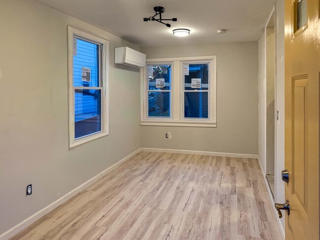 Livingroom with wall mounted heat and air system - 511 Spottswood St