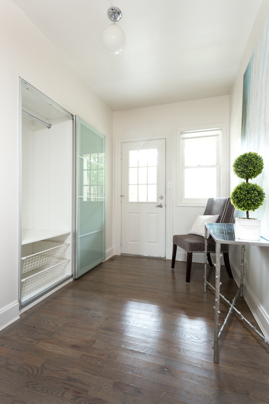 The foyer of this lovely townhome welcomes you to all the essentials: a custom closet and the perfect spot to kick off your shoes and come home to relax. - Westover Townhomes