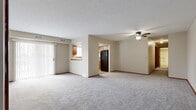 Located at 1420 Clearbrooke Dr in Brunswick, Ohio, this single-floor unit offers four bedrooms and one bathroom within a efficiently arranged floor plan. The living room serves as the central gathering space, finished with neutral-toned carpet and a ceiling fan with integrated light fixture. A sliding glass door with vertical blinds fills the room with natural light and provides outdoor access. The living area connects directly to the kitchen through a doorway, while a pass-through window with a raised counter creates visual continuity between the two spaces.

The kitchen features warm oak cabinetry, light vinyl plank flooring, a double-basin sink beneath a window, and black appliances including a dishwasher and refrigerator. A textured ceiling is consistent throughout the unit.

The four bedrooms are accessed via a carpeted hallway. Each room is finished with neutral walls, carpet, and wood-trimmed doors. The primary bedroom offers a comfortable footprint with a closet and natural light from a window with outdoor views. Additional bedrooms include closet access via bifold doors.

The single full bathroom is finished with vinyl plank flooring, an oak vanity with a countertop sink, a standard tub/shower combination, and a toilet, offering a clean and functional layout.