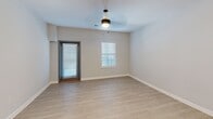This contemporary 1050 square foot apartment in Collegedale, Tennessee, offers a harmonious blend of comfort and functionality. The open-concept design seamlessly integrates the living room and kitchen, creating a spacious atmosphere ideal for both relaxation and entertainment. The kitchen features modern appliances, including stainless steel refrigerator and oven, complemented by wooden cabinetry and a striking marble-look countertop island.

Two well-appointed bedrooms provide ample personal space, with the primary bedroom boasting 200 square feet. Both bedrooms are carpeted for comfort and feature large windows that allow natural light to flood the rooms. The two full bathrooms are designed with practicality in mind, offering shower-tub combinations, single vanities with storage, and modern fixtures.

The apartment's neutral color palette, dominated by light grey walls and warm wood-look flooring, creates a bright and inviting ambiance throughout. Recessed lighting and strategically placed fixtures ensure well-lit spaces. An in-unit laundry room with full-sized washer and dryer adds convenience to daily living.

Additional features include closet spaces for storage and window treatments for privacy. The overall design emphasizes clean lines and a minimalist aesthetic, making it an ideal canvas for personal styling while maintaining a modern, fresh appeal.