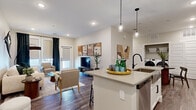 Located at 1595 Twin Lakes Ave in the Beartooth neighborhood of Bozeman, Montana, this thoughtfully designed 2-bedroom, 2-bathroom home offers a seamless single-floor layout with modern finishes throughout. The open-concept kitchen and living area serves as the heart of the home, featuring crisp white shaker cabinetry, a subway tile backsplash, stainless steel appliances, and a large center island with pendant lighting and bar seating — ideal for both everyday living and entertaining. A walk-in pantry provides generous storage, while wood-look flooring runs throughout, tying the spaces together cohesively. The living room offers natural light through a sliding glass door and roller shades, creating a bright and comfortable atmosphere. The primary bedroom is well-proportioned, with multiple windows allowing abundant natural light, and connects directly to a private en-suite bathroom featuring a walk-in glass shower, white vanity with quartz countertop, and an LED-backlit mirror. The second bathroom mirrors this refined aesthetic with industrial-style open shelving and a backlit vanity mirror. A dedicated laundry room houses a full-size side-by-side washer and dryer with overhead shelving. Two closets provide additional storage, completing this well-appointed Bozeman home.