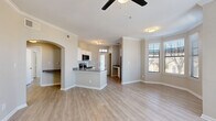 This thoughtfully designed 2-bedroom, 2-bathroom single-floor residence offers a functional and comfortable layout across a well-proportioned floor plan. Light wood-style flooring runs consistently throughout, creating a cohesive and clean aesthetic from room to room.

The living room serves as the heart of the home, featuring a classic white-mantled fireplace, crown molding, a ceiling fan, and multiple windows fitted with horizontal blinds that invite natural light. An elegant arched passageway connects the living area to the rest of the home.

The kitchen is equipped with stainless steel appliances, white cabinetry, subway tile backsplash, and dark countertops. A peninsula provides additional prep and dining space, while a transom-topped entry door and a dedicated window bring in abundant natural light.

The primary bedroom offers a comfortable footprint with a bay window configuration, providing generous views and light. It is complemented by a walk-in closet with built-in wire shelving. Both bathrooms feature white cabinetry, dark countertops, brushed nickel fixtures, and framed mirrors, with one bathroom including a full tub-shower combination.

The second bedroom is a well-sized, neutral room with ample wall space. Additional spaces include two hallways, two closets, and a utility room, rounding out a practical and livable floor plan.