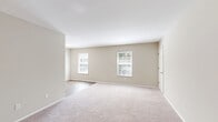 Located at 222 Merrimac Trail in Williamsburg, Virginia, this single-floor residence offers a functional and comfortable layout across two bedrooms, one full bathroom, and a living room. The living area is generously proportioned, featuring neutral-toned walls, soft carpeting, and multiple windows that draw in natural light and provide views of the surrounding greenery. The open flow between the carpeted and hard-surface flooring areas adds visual distinction to the living space.

The primary bedroom is a well-sized room with plush carpeting, neutral walls, and a window that frames outdoor views. It includes multiple closets — notably a double-door closet alongside additional storage options — offering ample organizational space. The second bedroom is comparably comfortable, also featuring carpet flooring, a window for natural light, and its own closet access.

The full bathroom is finished with wood-look plank flooring and includes a full-size tub and shower combination, a toilet, and a vanity with sink — all presented in a clean, bright white palette.

Throughout the residence, consistent neutral tones, white trim, and panel-style doors create a cohesive and understated aesthetic. The single-story layout ensures easy accessibility, making this a practical and well-appointed space in the heart of Williamsburg, VA.