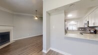 This single-story unit in Clearwater, Florida offers a well-designed layout that balances comfort and functionality throughout. The living room serves as a central gathering space, highlighted by a corner fireplace with a classic white mantel, crown molding, a ceiling fan, and wood-style flooring that extends throughout the unit. Natural light filters in through windows fitted with blinds, contributing to a bright and airy atmosphere.

Adjacent to the living area, the kitchen is outfitted with white shaker-style cabinetry, light quartz countertops, a gray subway tile backsplash, and stainless steel GE appliances including a range and over-the-range microwave. A pass-through opening connects the kitchen to the main living space, enhancing the open flow of the floor plan.

The bedrooms are generously sized, each featuring wood-style flooring, ceiling fans, and ample natural light. The two bathrooms include wood-style flooring, white vanities, and one features a tiled tub-shower combination. A dedicated in-unit laundry area accommodates a full-size GE washer and dryer. Throughout the unit, textured walls, crown molding, and consistent finishes create a cohesive and well-maintained interior.