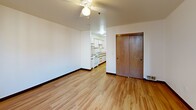 Located at 920 NW Kearney Street in Portland, Oregon, this efficiently designed studio offers a well-organized single-floor layout that makes smart use of every square foot. The open main living area features warm hardwood-style flooring throughout, crisp white walls, and a ceiling fan overhead, creating a bright and comfortable atmosphere. A large window allows natural light to fill the space while offering views of the surrounding urban neighborhood.

The galley-style kitchen is thoughtfully equipped with white cabinetry featuring wood-trimmed accents, ample counter space, an electric range, and a full-size refrigerator. A double-basin sink with under-counter storage adds practicality to the cooking area. The kitchen flows seamlessly into the main living space, lending an open, connected feel to the layout.

A sliding wood-panel closet door provides convenient storage within the main room, while the bathroom includes a full soaking tub with a clean white surround. The unit is accessed through a solid wood entry door. Consistent wood-toned trim and warm flooring tie the interior together cohesively. Situated in Portland's vibrant Northwest neighborhood, this studio offers an ideal base for urban living with a straightforward and functional design.