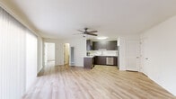 This thoughtfully designed 1-bedroom, 1-bathroom unit offers a bright and functional layout across a single floor. Light hardwood-style flooring runs throughout the entire space, creating a cohesive and clean aesthetic from room to room.

The open-concept living and kitchen area serves as the heart of the unit. The living room features a ceiling fan with a light fixture and large sliding glass doors dressed with vertical blinds, inviting natural light and providing access to an outdoor area. The kitchen is equipped with dark wood-toned cabinetry, white countertops, and a full suite of stainless steel appliances including a refrigerator, dishwasher, microwave, and range. A peninsula with counter seating connects the kitchen to the living area, enhancing the sense of open space and functionality.

The bedroom is a comfortable, well-proportioned room with its own ceiling fan, a window with blinds for natural light and privacy, and a sliding-door closet offering generous storage. The bathroom is clean and modern, featuring a dark wood vanity with a white countertop, framed mirror, and a full shower-tub combination. Throughout, the unit maintains a neutral, contemporary palette that maximizes brightness and versatility.