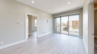 Located in Marion, Iowa, this thoughtfully designed 3-bedroom, 2-bathroom residence offers a clean, modern aesthetic throughout its single-floor layout. Light-toned luxury vinyl plank flooring flows seamlessly across the entire space, complementing the neutral wall palette and crisp white trim.

The kitchen is a standout feature, boasting warm-toned cabinetry with sleek hardware, white quartz countertops, a classic subway tile backsplash, and a full suite of stainless steel appliances including a range, over-the-range microwave, dishwasher, and refrigerator. Recessed lighting adds a polished finishing touch.

The open living area is bright and airy, highlighted by sliding glass doors that lead to a private balcony—ideal for taking in outdoor views. Recessed ceiling lights illuminate the space evenly.

The spacious primary bedroom includes a dedicated closet and direct sightlines to the kitchen area. The two additional bedrooms each feature ceiling fans, large windows that invite natural light, and light wood-tone flooring. Both bathrooms are finished consistently, with wood-tone vanities, light quartz countertops, tub-shower combinations, and wood-look flooring. Two closets provide ample storage throughout the residence.