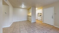 Located at 710 N 46th St in Killeen, Texas, this single-story 2-bedroom, 1-bathroom home offers a practical and functional layout. The living area features large tile flooring and a sliding glass door with vertical blinds that allows natural light to fill the space. Adjacent to the living room, the dining area flows conveniently into the kitchen, which is equipped with white cabinetry, a white electric range, microwave, and refrigerator. A pass-through countertop connects the dining and kitchen areas, enhancing the open feel. Both bedrooms are carpeted and feature neutral-toned walls with textured ceilings. The primary bedroom includes a ceiling fan with light fixture and offers a comfortable, well-proportioned layout. The second bedroom features a built-in closet with bi-fold doors, providing ample storage. A hallway connects the bedrooms to the shared full bathroom, which includes a tub/shower combo and tile flooring. Throughout the home, consistent warm neutral tones and clean white trim create a cohesive aesthetic. Two closets offer additional storage solutions, completing this straightforward and efficient floor plan.