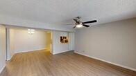 Located at 7021 West McDowell Road in Phoenix, Arizona, this single-floor, 2-bedroom, 3-bathroom residence offers a well-organized and practical layout. The open living room is a welcoming central space, featuring light wood-look flooring, neutral-toned walls, a textured ceiling, and a ceiling fan with integrated lighting. It flows naturally into the kitchen, which is equipped with stainless steel appliances—including a refrigerator, range, microwave, and dishwasher—white cabinetry, light countertops, and track lighting overhead. Both bedrooms are comfortably sized, each featuring the same wood-look flooring, neutral walls, textured ceilings, and windows with vertical blinds that allow natural light to filter in. The primary bedroom is supported by a dedicated closet with built-in shelving and hanging rods, offering organized storage. The bathrooms are clean and functional; the primary bathroom features a wide vanity with white cabinetry, a large mirror, and a shower with curtain. The additional bathrooms maintain a consistent, understated aesthetic throughout. The overall ambiance of this residence is clean, neutral, and move-in ready, with consistent finishes across all rooms that create a cohesive and practical living environment.