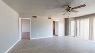 Located at 601 George Ave in Midland, Texas, this single-story home offers four bedrooms and one bathroom across a comfortable and functional floor plan. Wood-look tile flooring runs throughout the majority of the home, providing a cohesive and easy-to-maintain finish. Ceiling fans are present in multiple rooms, ensuring year-round comfort.

The living area is bright and open, featuring sliding glass doors that invite natural light and provide outdoor access. A textured ceiling and neutral gray walls give the space a clean, understated character. One wall features distinctive vertical wood panel detailing, adding a touch of architectural interest.

The kitchen is equipped with white cabinetry, a gas range, a tile backsplash, and a peninsula counter that offers additional prep space. Tile flooring and ample cabinet storage make it a practical workspace.

The primary bedroom is generously sized, featuring a ceiling fan and natural light from a window. The remaining three bedrooms are well-proportioned, each with ceiling fans, wood-look tile floors, and closets fitted with louvered bifold doors and built-in shelving.

The bathroom includes a wide vanity with dual sinks, a large mirror, and tile flooring, offering functional convenience for the household. Overall, the home presents a straightforward, practical layout well-suited for everyday living in Midland, TX.