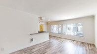 Located at 802 N W Knoll Dr in West Hollywood, CA, this one-bedroom, one-bathroom unit offers a thoughtfully designed single-level layout with a clean, modern aesthetic throughout. Wood-look flooring and crisp white walls with crown molding create a cohesive, bright atmosphere across all rooms.

The combined kitchen and living area forms the heart of the unit. The kitchen features white shaker-style cabinetry with brushed nickel hardware, gray quartz countertops, a gas range, refrigerator, and a stainless steel sink. A peninsula counter provides a natural divide between the kitchen and the open living space, which is bathed in natural light from large windows. A wall-mounted mini-split system ensures year-round comfort.

The bedroom is a well-proportioned retreat with a ceiling fan, crown molding, and a large window framing lush greenery outside. Three closets distributed throughout the unit provide generous storage options.

The bathroom includes a tub and shower combination enclosed by a sliding glass door, finished with clean white tile surround. A hallway connects the main living areas and provides additional flow throughout the space. This unit offers a practical, move-in-ready layout ideally situated in the heart of West Hollywood.
