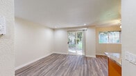 Located in Edmonds, Washington, this well-appointed one-bedroom, one-bathroom unit offers a thoughtfully designed single-floor layout. The combined kitchen and living area serves as the heart of the home, finished with durable hardwood-style flooring and recessed lighting that keeps the space bright and welcoming. A sliding glass door in the living area floods the room with natural light and opens to a view of lush greenery outside, creating a seamless connection to the outdoors. An additional window further enhances the airy feel of the space.

The kitchen features warm-toned wood cabinetry, granite-style countertops, and a full suite of stainless steel appliances including a range, over-the-range microwave, and refrigerator — providing both style and functionality in a compact footprint.

The bedroom is carpeted for comfort and includes a sliding-door closet with a full hanging rod, offering practical storage. A window brings in natural light and outdoor views. The bathroom is finished with matching wood cabinetry, a granite-style vanity top, and a full tub-shower combination with clean white surrounds and hardwood-style flooring, creating a cohesive and tidy aesthetic throughout the unit.