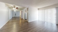 Located at 200 W Columbine Ave in Santa Ana, California, this single-floor residence offers a well-organized layout with a clean, neutral aesthetic throughout. The open living area is finished with durable wood-look flooring and features a ceiling fan, a textured ceiling, and full-wall mirrored closet panels that reflect natural light and add a sense of spaciousness. Vertical blinds on a large sliding window provide adjustable light control and access to outdoor views.

The kitchen is thoughtfully designed with gray shaker-style cabinetry, light quartz countertops, a stainless steel sink, and mosaic tile backsplash accents. A large window fitted with vertical blinds overlooks the exterior, keeping the space bright and airy.

The bedroom is carpeted for comfort, features a wall-mounted air conditioning unit, and includes a generously sized window with views of the surrounding area and access to a balcony. An additional carpeted room provides flexible space for various uses.

The bathroom is equipped with a wide gray vanity, quartz countertop, a large mirror, and ample cabinet and drawer storage. The layout is practical and well-appointed. Throughout the unit, consistent finishes including wood-look flooring, gray cabinetry, and white walls create a cohesive and modern living environment.