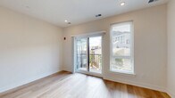 Located at 130 W Girard Ave in Philadelphia's vibrant Northern Liberties neighborhood, this modern studio unit offers a thoughtfully designed, efficient layout with contemporary finishes. The open-plan living and dining area is bright and airy, featuring light hardwood flooring, recessed lighting, and large sliding glass doors that lead to a private balcony with open views of the surrounding Philadelphia cityscape. The galley-style kitchen is well-appointed with warm wood-toned cabinetry, white quartz countertops, a subway tile backsplash, and a full suite of stainless steel appliances including a gas range, built-in microwave, dishwasher, and refrigerator. The bathroom is finished with large-format tile flooring, a wood-front vanity with a white countertop, and a glass-enclosed walk-in shower with floor-to-ceiling tile surround. Two closets provide ample storage, and an in-unit laundry area adds everyday convenience. Clean white walls, consistent flooring throughout, and an abundance of natural light from multiple windows give the space a crisp, modern ambiance that is both functional and inviting.
