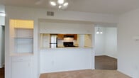 Located at 3613 Pine Lake Dr in Fayetteville, NC, this single-floor residence offers a well-organized layout designed for comfortable everyday living. The living area is a welcoming space anchored by a wood-burning fireplace with a classic white mantel and plush carpeting underfoot. A ceiling fan with integrated lighting provides year-round comfort, while sliding glass doors open to an outdoor area, filling the room with natural light and offering a seamless indoor-outdoor connection.

The kitchen is positioned behind a pass-through counter, creating an open feel between the cooking and living spaces. It features warm wood cabinetry, a black electric range with overhead ventilation, light countertops, and durable hardwood-style flooring. An adjacent dining area with a decorative chandelier completes the space.

The bedrooms are carpeted and bright, each benefiting from natural light through window treatments. One bedroom includes built-in shelving and closet storage, while another features a bifold-door closet. The bathrooms are functional and clean, with wood-tone vanity cabinetry, tile flooring, a tub/shower combination, and a separate walk-in shower unit. Throughout the home, a neutral color palette and consistent finishes create a cohesive and move-in ready environment.