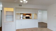 Located at 3613 Pine Lake Dr in Fayetteville, NC, this single-floor residence offers a well-organized layout designed for comfortable everyday living. The living area is a welcoming space anchored by a wood-burning fireplace with a classic white mantel and plush carpeting underfoot. A ceiling fan with integrated lighting provides year-round comfort, while sliding glass doors open to an outdoor area, filling the room with natural light and offering a seamless indoor-outdoor connection.

The kitchen is positioned behind a pass-through counter, creating an open feel between the cooking and living spaces. It features warm wood cabinetry, a black electric range with overhead ventilation, light countertops, and durable hardwood-style flooring. An adjacent dining area with a decorative chandelier completes the space.

The bedrooms are carpeted and bright, each benefiting from natural light through window treatments. One bedroom includes built-in shelving and closet storage, while another features a bifold-door closet. The bathrooms are functional and clean, with wood-tone vanity cabinetry, tile flooring, a tub/shower combination, and a separate walk-in shower unit. Throughout the home, a neutral color palette and consistent finishes create a cohesive and move-in ready environment.