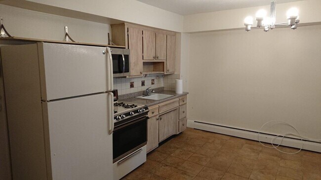 Open kitchen refrigerator and oven range - 6130 Booth St