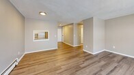 This well-appointed 2-bedroom, 1-bathroom residence in Malden, MA offers a practical and comfortable single-floor layout. Light wood-style flooring runs consistently throughout the space, creating a clean, cohesive look from room to room. The kitchen features white shaker-style cabinetry, a marble-look tile backsplash, ample counter space, and white appliances including a gas range and refrigerator — all complemented by a pass-through window that connects to the living area. The living room is generously sized, filled with natural light from multiple windows, and includes baseboard heating. A pass-through to the kitchen adds an open, connected feel to the main living area. The spacious primary bedroom features two large windows with views of surrounding greenery, baseboard heating, and an expansive wall of louvered bi-fold closet doors offering substantial storage. The second bedroom is well-proportioned with its own window and baseboard heat. The full bathroom includes a tiled tub/shower combination and wood-style flooring. Neutral warm-beige walls throughout the residence contribute to a calm, move-in-ready ambiance well suited to everyday living in the greater Boston area.