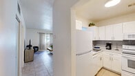 Located at 2450 S Park Rd in Pembroke Park, FL, this one-bedroom, two-bathroom residence offers a well-organized single-floor layout designed for comfortable everyday living. The open-concept living and dining area is finished with light-toned ceramic tile flooring and features a bright window with sheer curtains that invite natural light into the space. The living area provides ample room for seating and entertainment, with clean white walls that create a fresh, airy atmosphere throughout.

The kitchen is outfitted with white cabinetry, light stone-style countertops, a gray subway tile backsplash, and white appliances, including a range with over-the-range microwave. The layout is efficient and functional, flowing naturally into the dining and living areas.

The generously sized primary bedroom accommodates a full bed with ease and benefits from a window with soft draping curtains, continuing the tile flooring found throughout the unit. A dedicated closet provides additional storage.

Two bathrooms serve the residence: one features a tub-shower combination with glass sliding doors and tile surround, while the second offers a vanity with marble-style countertop and a window for natural ventilation. The overall aesthetic is light, coastal-inspired, and move-in ready.