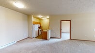 Located at 1090 W Betz Rd in Cheney, WA, this single-floor residence offers two bedrooms and two full bathrooms within a thoughtfully arranged floor plan. The open-concept living, dining, and kitchen area forms the heart of the home, creating a spacious and connected environment for everyday living. The kitchen features warm wood-toned cabinetry, white appliances including a refrigerator and range, and a peninsula with a breakfast bar that separates it from the living and dining space. Textured ceilings and neutral-toned walls run throughout, complemented by consistent carpet flooring and wood-trimmed doorways and baseboards. Both bathrooms are well-appointed with tub/shower combos, wood-cabinet vanities, tile flooring, and large mirrors. Each bedroom offers comfortable proportions, with the primary bedroom providing a closet with sliding wood-panel doors. Natural light filters into the bedrooms through windows fitted with blinds, and baseboard heating ensures year-round comfort. A dedicated closet space houses a full-size washer and dryer, adding everyday convenience. The layout is practical and efficient, making this residence a functional and comfortable home in Cheney, Washington.