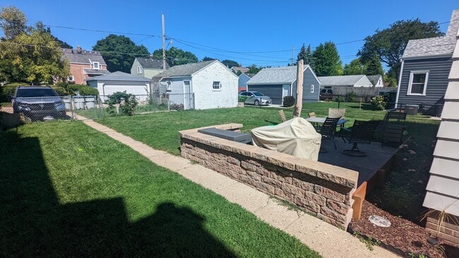 Fenced in yard with paver patio - 3579 S Logan Ave