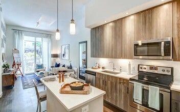 Open-Concept Layout With Full Kitchen and Connected Living and Dining Furniture - Pearl Flagler Village