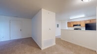 Located at 7875 W Mansfield Pkwy in Lakewood, Colorado, this one-bedroom, one-bathroom residence offers a well-organized single-floor layout designed for comfortable everyday living. The galley-style kitchen is equipped with warm honey-toned wood cabinetry, a black appliance suite including a range, refrigerator, and dishwasher, and a double-basin sink set into a white countertop. A peninsula with a white countertop separates the kitchen from the living area, providing additional prep space and a natural transition between the two zones. The living area features neutral carpet flooring and a clean, open feel with light-toned walls throughout. The bedroom is a comfortable, carpeted retreat with a window that brings in natural light and a view of the surrounding exterior. It features two separate doorways — one leading to a dedicated walk-in closet with hanging rod storage, and another to an additional room. The full bathroom is finished with tile flooring and includes a full-size soaking tub and shower combination with chrome fixtures. A dedicated closet completes the layout, adding practical storage to this efficiently designed Lakewood residence.