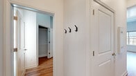 Located at 904 N Garland Ave in Fayetteville, Arkansas, this well-designed one-bedroom, one-bathroom unit makes smart use of its compact footprint across a single floor. Warm hardwood-style flooring runs consistently throughout the space, lending a cohesive and inviting feel to every room.

The kitchen is a functional highlight, featuring a full suite of stainless steel appliances — including a refrigerator, electric range, over-the-range microwave, and dishwasher — complemented by crisp white cabinetry that extends to the ceiling for ample storage. Light countertops and a ceiling fan overhead enhance the open, airy character of the space.

The bedroom is a cozy, practical room with a wall-mounted TV bracket already in place and access to a dedicated closet fitted with shelving for organized storage. The hallway connects the living areas seamlessly and includes a set of wall-mounted hooks, ideal for coats and bags.

The bathroom is clean and straightforward, offering a full tub-shower combination, a white vanity with storage cabinetry above, and the same warm flooring that ties the unit together. Throughout, the soft neutral wall tones and bright white trim create a clean, modern aesthetic that feels welcoming and move-in ready.