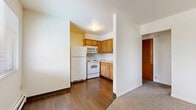 Located at 680 Riverview Dr in Columbus, Ohio, this one-bedroom, one-bathroom unit offers a practical and well-organized layout across a single floor. The combined kitchen and dining area is equipped with warm honey-toned wood cabinetry, white appliances including a refrigerator, electric range, microwave, and dishwasher, complemented by durable hardwood-style flooring. A partial wall separates the kitchen from the adjacent living and entry areas, creating a sense of openness while maintaining defined spaces. The spacious living room features neutral carpet, a baseboard heating system, and a window that allows natural light to filter in. The bedroom is a generously sized retreat, also finished with plush carpet and baseboard heat, with a large window offering views of the surrounding neighborhood. Two closets provide ample storage throughout the unit. The full bathroom includes a combined tub and shower with tile surround, a vanity with sink, hardwood-style flooring, and a window for natural ventilation. A hallway connects the main living spaces efficiently. The clean, neutral color palette throughout the unit creates a bright and functional living environment well-suited for everyday comfort.