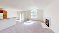 Located at 2427 Partridge Dr in Shelby Township, Michigan, this 2-bedroom, 2-bathroom residence offers a thoughtfully designed single-floor layout. The living room serves as the heart of the home, showcasing soaring vaulted ceilings, a striking arched window that floods the space with natural light, a tile-surround fireplace, and direct access to a private balcony. Soft carpeting and neutral walls create a bright, welcoming atmosphere throughout.

The kitchen features warm honey-toned cabinetry, granite-look countertops, a peninsula with a built-in sink, and full white appliance package, all set on easy-care hardwood-style flooring. A pendant light over the peninsula connects the kitchen seamlessly to the living area.

The primary bedroom offers vaulted ceilings, a double-door closet, and a dedicated en-suite bathroom with warm wood vanity cabinetry, granite-look countertops, and a walk-in glass-door shower with tile surround. The second bedroom is carpeted and filled with natural light from a well-positioned window. A second full bathroom with tile flooring and a wood vanity serves the remaining rooms. Completing the layout is a dedicated in-unit laundry room with hardwood-style flooring, a utility sink, and a full-size washer and dryer hookups.