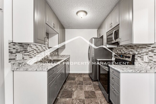 Building Photo - Updated Condo With 2 Covered Parking Spots...