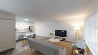 Located at 7625 N 19th Ave in Phoenix, Arizona, this single-floor residence offers a thoughtfully designed layout with a clean, modern aesthetic throughout. The open-concept living and dining area is bright and welcoming, featuring wood-style flooring, a large window with vertical blinds that invites natural light, and a textured ceiling. The space flows seamlessly, offering room for both comfortable lounging and casual dining.

The kitchen is a standout feature, outfitted with crisp white shaker cabinetry, granite-style countertops, and a full suite of stainless steel appliances including an electric range, built-in microwave, dishwasher, and refrigerator. A breakfast bar adds functional counter space and provides a natural divide between the kitchen and dining area. Wood-look flooring ties the kitchen cohesively to the main living spaces.

The bedroom is generously sized with plush carpeting, a ceiling fan with light fixture, and a wide closet with bi-fold doors offering ample storage. The neutral palette and soft finishes create a calm, restful atmosphere.

The bathroom features a walk-in shower, a white vanity with stone-look countertop, brushed nickel hardware, and wood-style flooring, combining practicality with a polished, updated look throughout.