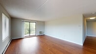 Located at 650 Bulfinch Dr in Andover, Massachusetts, this single-floor residence offers a well-organized layout with a comfortable blend of hardwood flooring and plush carpeting throughout its living spaces. The open living area is a standout feature, showcasing warm hardwood floors, soft neutral walls, and a sliding glass door that leads to a private balcony overlooking lush greenery — filling the space with abundant natural light. A hallway connects the living area to the rest of the home with ease.

The kitchen is thoughtfully appointed with warm wood cabinetry reaching to the ceiling, dark granite countertops, stainless steel appliances including a refrigerator and range, and hardwood flooring — offering both functionality and style. Adjacent common areas continue the hardwood flooring and feature dual windows that frame pleasant outdoor views.

The bedrooms are carpeted for comfort, each with large windows that invite natural light and baseboard heating. One bedroom includes a walk-in closet, providing ample storage. The bathroom is clean and well-finished, featuring a full tub/shower combination, a white vanity with dark granite countertop, and hardwood flooring. Textured ceilings are consistent throughout, adding a classic residential character to the overall space.