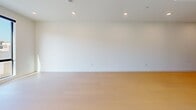 Located at 806 N Edinburgh Ave, Unit 303, in Los Angeles, CA, this contemporary 2-bedroom, 2-bathroom third-floor condo offers 940 square feet of thoughtfully designed living space. The unit features light wood flooring throughout and a clean, minimalist aesthetic defined by crisp white walls and recessed lighting. The open-concept kitchen is appointed with sleek, light wood cabinetry, white quartz countertops, a tile backsplash, stainless steel dishwasher, a built-in wine refrigerator, and a stylish pendant light, flowing seamlessly into the main living area. Floor-to-ceiling windows with black steel frames flood the living spaces with natural light and offer views of the surrounding Los Angeles neighborhood, including glimpses of palm trees. The primary bedroom spans 150 square feet and features large corner windows and a built-in closet with paneled doors. The second bedroom also benefits from oversized windows. The primary bathroom showcases a large walk-in glass shower with floor-to-ceiling tile, a built-in bench, and a modern floating toilet. The second bathroom includes a wood-toned vanity with white countertop, a framed mirror with vanity lighting, and a soaking tub. A hallway connects all rooms, completing this polished and light-filled urban retreat.