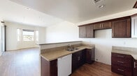 Located at 14105 Chadron Ave in Hawthorne, CA, this one-bedroom, one-bathroom unit offers a well-organized, single-floor layout that makes efficient use of its space. Rich wood-style flooring flows throughout the main living areas and bedroom, creating a warm and cohesive aesthetic.

The kitchen is a standout feature, showcasing rich dark cabinetry with ample upper and lower storage, granite-style countertops, a double-basin sink, and a dishwasher. A peninsula counter connects the kitchen to the living area, offering additional prep space and creating an open, functional flow between rooms.

The living room is bright and spacious, featuring recessed lighting, large windows, and a sliding glass door that opens directly onto a private balcony with outdoor views — allowing natural light to fill the space throughout the day.

The bedroom is generously sized, with its own sliding door access to the balcony, wood-style flooring, and a dedicated closet. The bathroom includes a combined tub and shower enclosed by sliding glass doors, a granite-topped vanity with dark cabinetry, and light wood-tone tile flooring.

A hallway connects the main rooms with ease. The overall design is clean and contemporary, with neutral tones and modern finishes throughout.