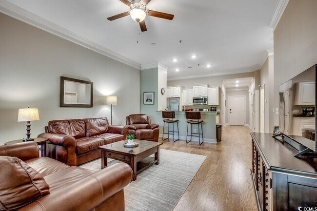Great living room with high ceilings, room for a table, and bar height countertop seating - 144 Puffin Dr