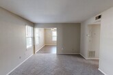 Located in Arnold, Missouri, this 2-bedroom, 1-bathroom residence offers a practical and comfortable single-floor layout. The kitchen is equipped with dark cabinetry, light countertops, stainless steel appliances including a dishwasher and refrigerator, and durable wood-look flooring that adds a modern touch. The living room is bright and welcoming, featuring wood-look flooring, a ceiling fan with light fixture, and multiple windows that bring in natural light. A carpeted entryway with a classic six-panel front door provides a clean transition into the main living area. Both bedrooms are carpeted and bathed in natural light from windows with blinds. The spacious primary bedroom includes double closets, offering generous storage. The second bedroom is well-sized with its own closet and window view. The bathroom is neatly finished with a white vanity, framed mirror, lighted vanity bar, a full tub and shower combination, and wood-look flooring that ties the space together. Neutral wall tones throughout the home create a calm, cohesive aesthetic that is easy to personalize.