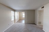 Located in Arnold, Missouri, this 2-bedroom, 1-bathroom residence offers a practical and comfortable single-floor layout. The kitchen is equipped with dark cabinetry, light countertops, stainless steel appliances including a dishwasher and refrigerator, and durable wood-look flooring that adds a modern touch. The living room is bright and welcoming, featuring wood-look flooring, a ceiling fan with light fixture, and multiple windows that bring in natural light. A carpeted entryway with a classic six-panel front door provides a clean transition into the main living area. Both bedrooms are carpeted and bathed in natural light from windows with blinds. The spacious primary bedroom includes double closets, offering generous storage. The second bedroom is well-sized with its own closet and window view. The bathroom is neatly finished with a white vanity, framed mirror, lighted vanity bar, a full tub and shower combination, and wood-look flooring that ties the space together. Neutral wall tones throughout the home create a calm, cohesive aesthetic that is easy to personalize.