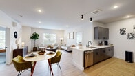 Located at 227 Pane Rd in Newington, CT, this well-appointed 2-bedroom, 2-bathroom residence offers a thoughtfully designed single-floor layout that maximizes both comfort and functionality. The open-concept living, dining, and kitchen area forms the heart of the home, anchored by light hardwood-style flooring and recessed lighting that create a bright, cohesive atmosphere. Large windows throughout invite abundant natural light and offer pleasant outdoor views.

The kitchen is designed for efficiency, featuring dark wood cabinetry with matte black hardware, white quartz countertops, subway tile backsplash, and stainless steel appliances including a range, microwave, dishwasher, and refrigerator. The galley-style layout maximizes counter and storage space.

The living area is open and airy, flowing seamlessly from the dining space, with multiple windows providing cross-ventilation and greenery views. A wall-mounted mini-split unit ensures year-round climate comfort.

The primary bedroom is a serene retreat with a closet, direct access to an en-suite bathroom, and natural light from a large window. The second bedroom is equally well-lit and comfortable. Both bathrooms are finished in a clean, modern aesthetic — one featuring a tub/shower combo and the other a walk-in tile shower — each with dark-framed fixtures and wood-toned vanities.