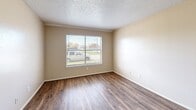 Located at 3241 Bonnie Dr in Fort Worth, TX, this single-floor, one-bedroom, one-bathroom unit offers a practical and functional layout designed to maximize every square foot. Throughout the space, rich wood-look laminate flooring provides a warm, cohesive aesthetic that ties each room together.

The open-concept living, dining, and kitchen area forms the heart of the unit. The kitchen features warm wood-toned cabinetry, a white electric range, and granite-look countertops with a tile backsplash. A large front-facing window fills the living area with natural light, while a textured ceiling adds visual character overhead. The front entry door is a classic six-panel design, providing a welcoming transition into the space.

The bedroom is a well-proportioned private retreat, complete with a ceiling fan with light fixture, neutral beige walls, and a window with blinds that allows for natural light. Three closets throughout the unit offer generous storage options, a notable feature for a space of this size.

The bathroom includes a full-size tub and shower combo with clean white surround and chrome fixtures, delivering straightforward functionality. A hallway connects the main living areas to the bedroom and bathroom, contributing to an efficient and logical flow throughout the home.