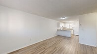 This 2-bedroom, 2-bathroom single-floor residence in Hialeah, Florida offers a clean, functional layout designed for comfortable everyday living. Light wood-style flooring runs throughout the home, complementing the crisp white walls and textured ceilings that lend a consistent, cohesive aesthetic across every room.

The kitchen is a standout feature, equipped with white cabinetry offering generous storage, stone-toned countertops, and a peninsula that opens toward the adjoining living area. White appliances including an electric range and refrigerator are included, and a window above the sink brings in natural light.

Both bedrooms are well-proportioned, bright, and finished with the same light wood flooring. Each room features a closet — one with sliding doors and another with a traditional hinged door — providing practical storage. Windows dressed with horizontal blinds allow natural light while maintaining privacy.

The two bathrooms are straightforward and functional. One features a tub-shower combination with warm beige tile surround and a handheld showerhead, while the second offers a vanity with a mirror and clean white fixtures.

The open, minimalist design of the home creates an airy feel throughout. The single-floor layout ensures easy accessibility, making this Hialeah residence a practical and well-appointed space.