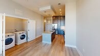 This contemporary 600 square foot apartment in Franklin, TN, offers a harmonious blend of style and functionality. The heart of the home is the open-concept kitchen, showcasing sleek gray cabinetry, stainless steel appliances, and a generous island with a sink, providing both preparation space and casual dining. Pendant lighting adds a touch of elegance, while the light wood flooring throughout creates a warm, inviting atmosphere.

The living area seamlessly connects to the kitchen, offering a versatile space for relaxation and entertainment. Large windows flood the room with natural light and provide scenic views. The bedroom, measuring 120 square feet, offers a cozy retreat with plush carpeting and ample closet space.

The bathroom is a testament to luxury, featuring a spacious tub surrounded by marble-like tile, with multiple grab bars for safety and convenience. Modern fixtures and finishes complete the spa-like ambiance. Additional amenities include in-unit laundry facilities, recessed lighting, and stylish window treatments.

This well-designed apartment maximizes its 600 square feet, creating a comfortable and efficient living space perfect for those seeking a contemporary urban lifestyle.